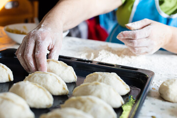  Woman cooking pies at home. Cooking and baking at home.