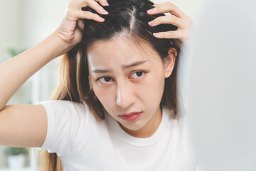 Hair loss problem, Asian woman look at scalp worry about balding. - obrazy, fototapety, plakaty