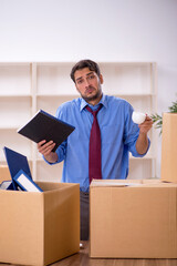 Young male employee in office relocation concept