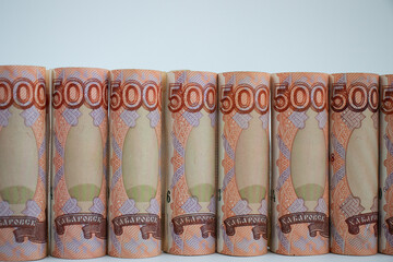 Russian money folded are in a raw on a white background.