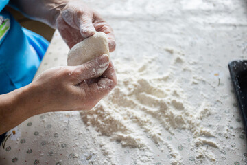 Female hands cooking from the dough. Baking.