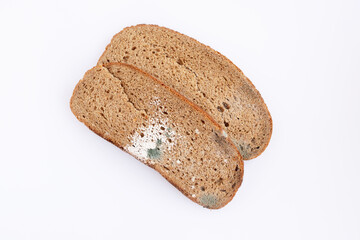 Slices of stale bread with mildew. Moldy fungus on spoiled bread. Food waste
