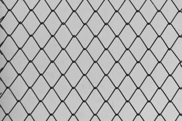 Fototapeta premium Steel Wire Mesh on Vintage White Wall Background