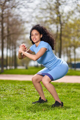 Portrait of a fitness woman doing warm up exercises outdoors. Athletic female strech after workout outside. Sport and people concept. Female athlete streching outdoors. Healthy sports lifestyle.