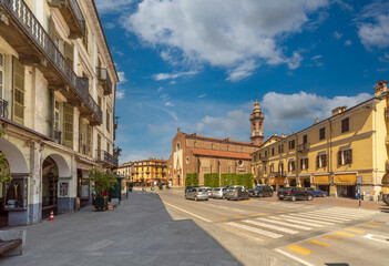 Fototapeta na wymiar Saluzzo, Cuneo, Italy - April 15, 2022: Piazza Risorgimento with historic buildings and the Cathedral of the Assumption of the Virgin Mary