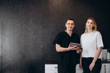 Plastic Cosmetic Surgeon Consults Woman about Facial Lift Surgery, He Draws Arrows on Digital...