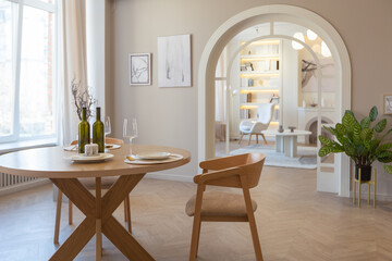 fashionable modern design luxury apartment in light colors. bright day behind huge windows. stylish decoration and no one inside.