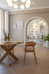 fashionable modern design luxury apartment in light colors. bright day behind huge windows. stylish decoration and no one inside.