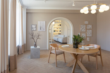 fashionable modern design luxury apartment in light colors. bright day behind huge windows. stylish decoration and no one inside.