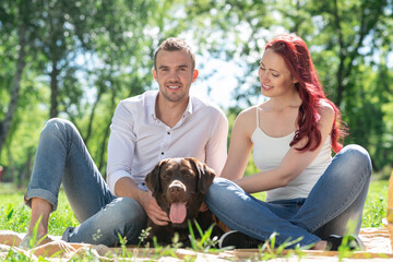 Couple with a dog in the park