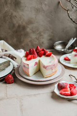 A simple cottage cheese casserole with sour cream filling and frozen strawberries. Beautiful homemade cheesecake with berries on the dining table