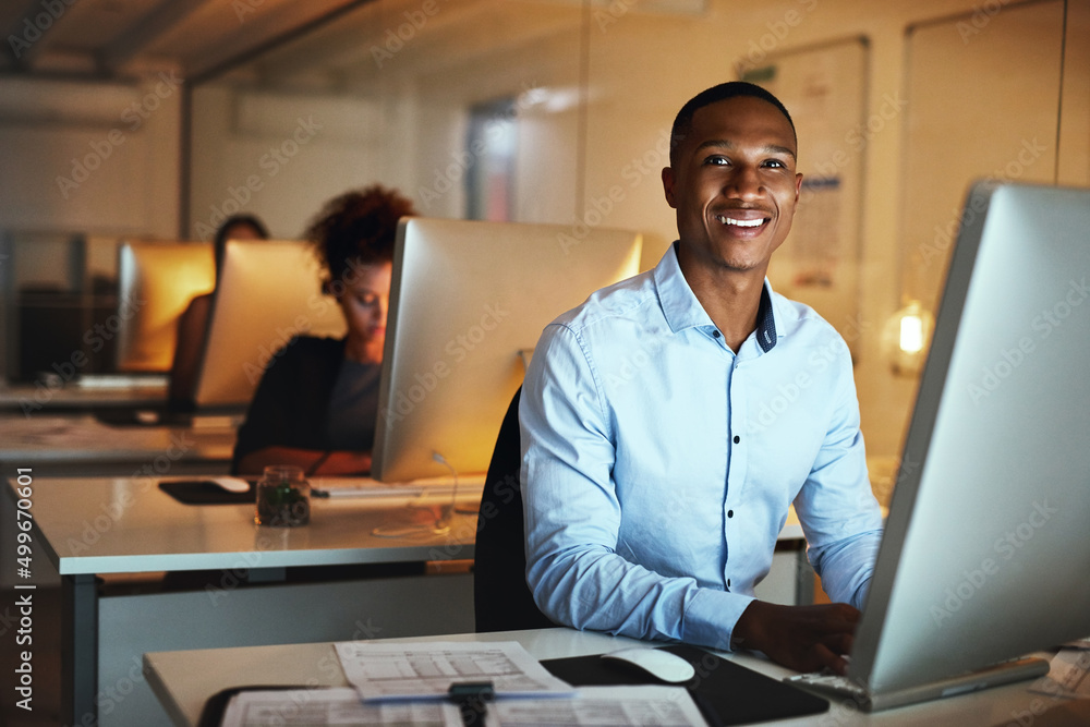 Poster here to get ahead of my deadlines. portrait of a young businessman working late on a computer in an 