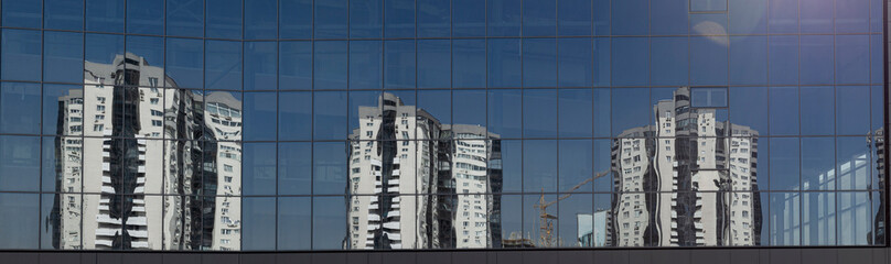 Fototapeta premium Reflection of houses in the mirror facade