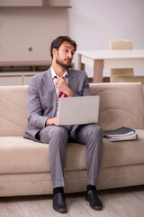 Young male employee working from home during pandemic