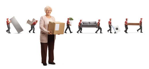 Full length portrait of an elderly woman holding a cardboard box and movers carrying items