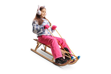 Girl sliding on a wooden sleigh