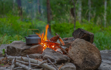Kettle on fire. Still life in nature.