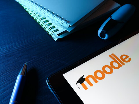 KYIV, UKRAINE - March 30, 2022. Tablet with moodle logo and notebooks.