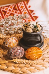Palm Sunday in the Ukrainian style. Easter eggs, quail eggs, embroidered towel. Black cup in vintage style. Easter in Ukraine.