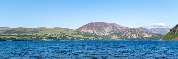 Obraz premium Wast Water or Wastwater is a lake located in Wasdale, a valley in the western part of the Lake District National Park, England, UK, beautiful summer day and blue cloudy sky
