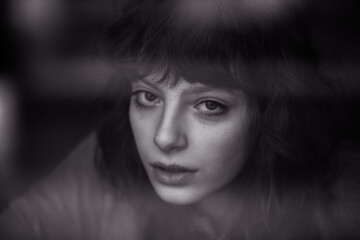 Portrait of a beautiful young woman with curly hair.