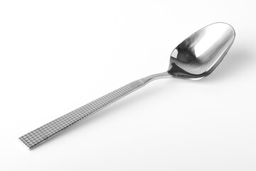 Stainless steel spoon on a white background. Close-up