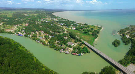 Panoramic aerial drone view of rural settlements by the riverside in Sedili Kecil, Johor, Malaysia