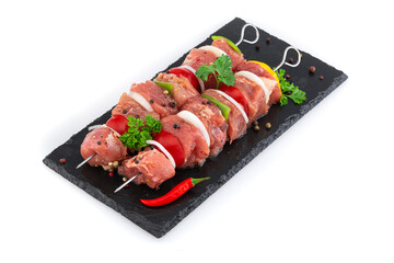 Meat kebab on skewers with pieces of vegetables