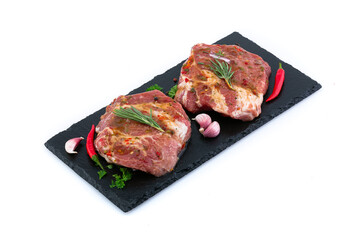 Pieces of meat with marinade on a black board