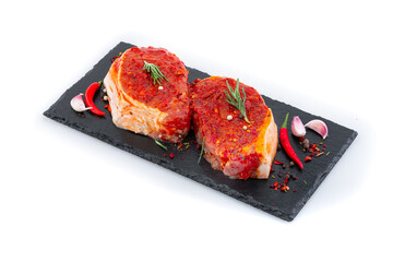 Pieces of meat with marinade on a black board