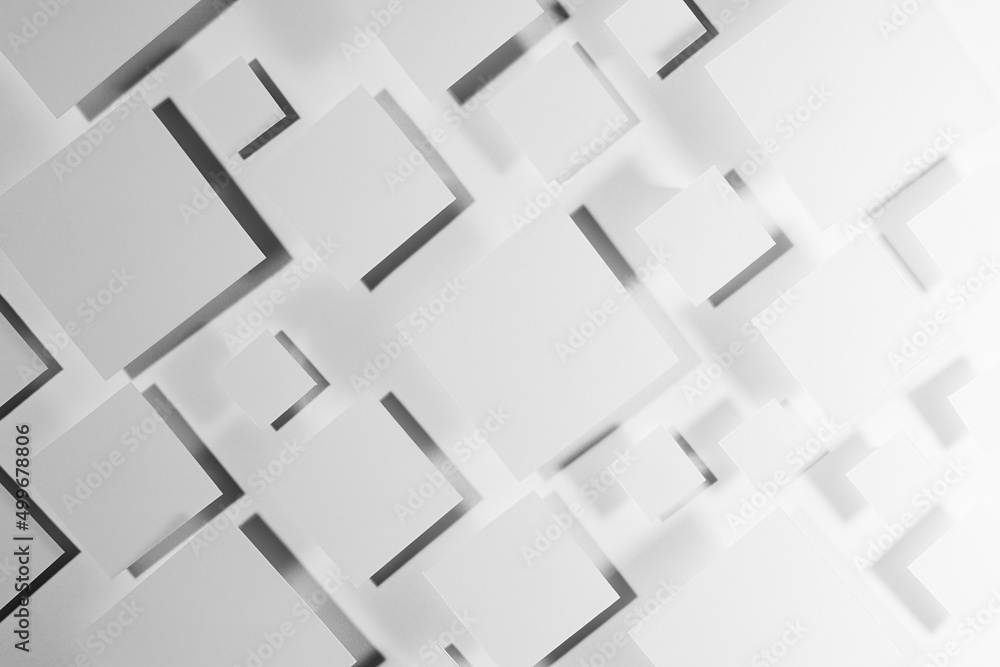 Poster grey geometric texture with flying rhombuses in hard light with contrast gradient dark shadows as ra