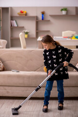 Young little girl doing housework at home