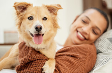 Hes all I need. Shot of a beautiful young woman relaxing on the couch with her dog at home.