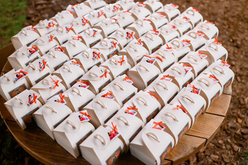 Above view of set of festive boxes, which wrapped in colorful paper and tied by red ribbon with...