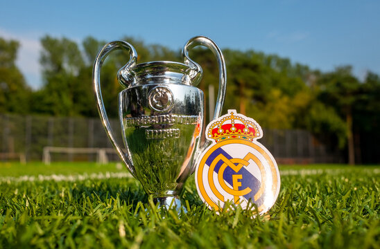 August 30, 2021, Madrid, Spain. The emblem of the football Real Madrid CF and the UEFA Champions League Cup on the green turf of the stadium.