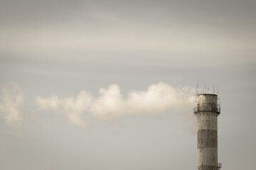 Smoke from the pipe of the heat station. Fuel. Sanctions. Energy. Environment. Pollution. Black and white