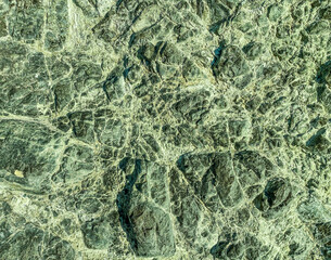 mountain texture. volumetric 3d background with a rock of stones and sand. rock with holes and burrows. solid stone, background from natural materials underwater