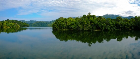 Panoramic view of dam water surrounded with green trees in Kuala Kubu Bharu, Selangor, Malaysia.