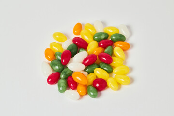 A heap of bright colorful jelly beans on white background