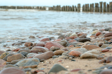 relaxation at sea. Stack of stones on beach. Stone cairn on natural background - blurred sea and sky. Concept balance