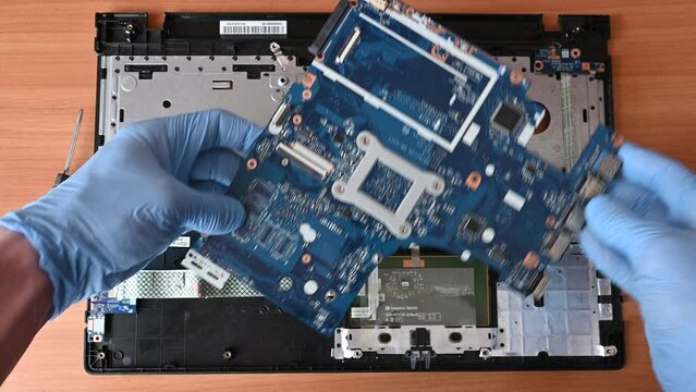 top view laptop motherboard repair, master in gloves repairs laptop, first person view