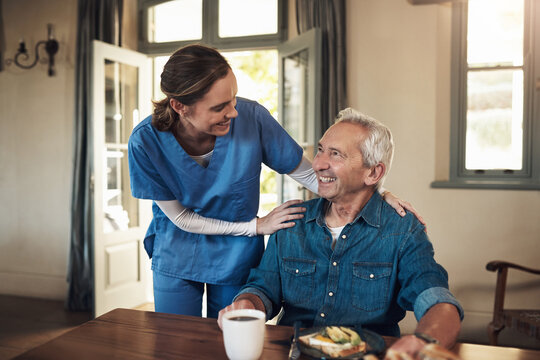 Nothing boosts my mood like good food. Shot of a young nurse checking up on a senior man during breakfast at a nursing home.