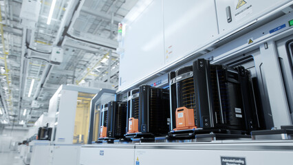 Row of Wafer FOUPs Inside Bright Advanced Semiconductor Production Fab Cleanroom with Working...