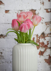 pink tulips in a light vase