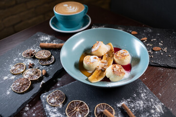 fresh coffee and cheese pancakes with banana, mango and berry sauce