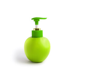 Apple with a dispenser on a white background. Green apple with plastic dispenser isolated on white background. The concept of natural cosmetic skin creams or soaps. Free space for text