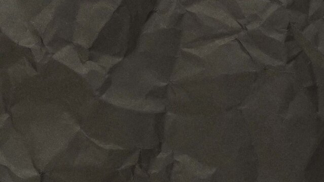 Wrinkled sheet of black paper. Textured backdrop