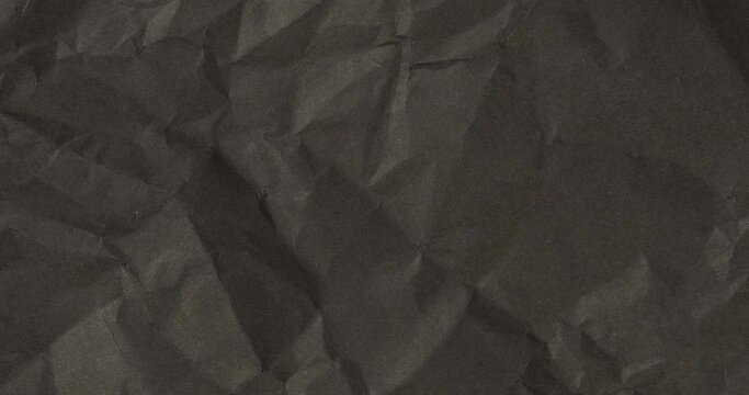 Wrinkled sheet of black paper. Textured backdrop