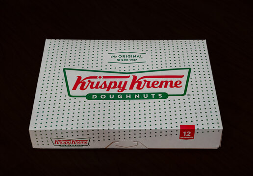 Krispy Kreme 12 donut box shot on a black background