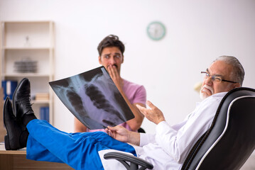 Young male patient visiting old male doctor radiologist